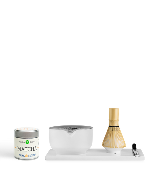 Fellow x Yama Matcha Set: tin, bamboo whisk, spoon, and ceramic bowl on a tray by Fellow.